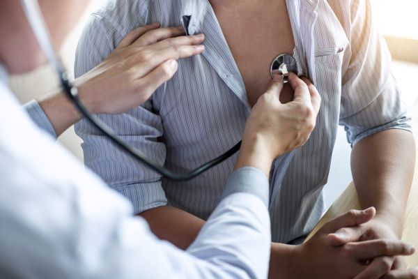 Health professional with a stethoscope, cardiovascular health screening and heart screening