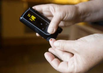 Diabetic patient testing her blood for sugar level