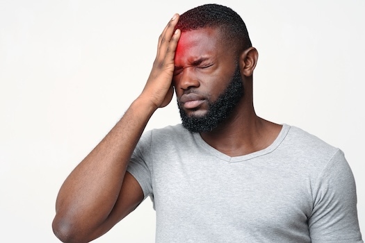 Man-holding-head-Botox-for-migraines