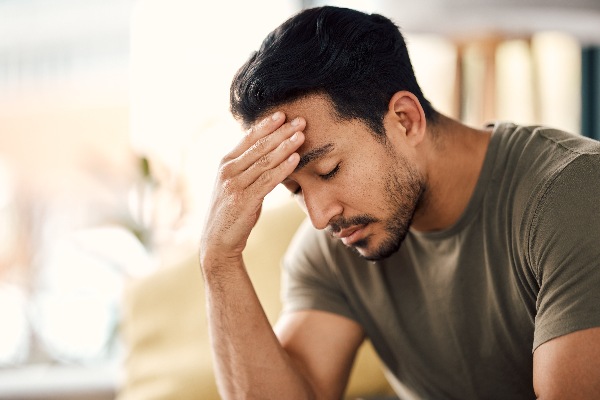 Man-with-beard-holding-head-with-hand-low-testosterone