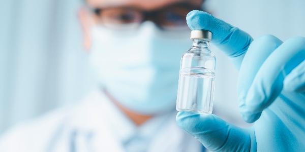 Physician-holding-vial-of-vaccine