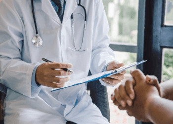 Doctor Communicating With A Patient During A Prostate Exam