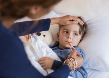 child on bed with the theorematic in mouth
